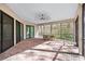 Relaxing screened porch with brick patio and wooded views at 9116 Exposition Dr, Tampa, FL 33626
