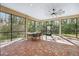Spacious screened porch with brick pavers and ceiling fan at 9116 Exposition Dr, Tampa, FL 33626