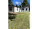 Charming white house with black trim and a spacious yard at 8465 N Tobay Rd, St Petersburg, FL 33702