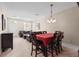 Bright dining room with a red tablecloth and dark wood table at 10308 Saville Rowe Ln, Tampa, FL 33626