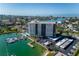 Aerial view of waterfront highrise building with marina and pool at 10355 Paradise Blvd # 207, Treasure Island, FL 33706