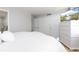 Relaxing bedroom with white bedding, built-in dresser, and large closet at 10355 Paradise Blvd # 207, Treasure Island, FL 33706
