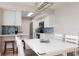 Modern dining area with white table and chairs at 10355 Paradise Blvd # 207, Treasure Island, FL 33706