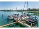 Boats docked at a marina with a wooden dock at 10355 Paradise Blvd # 207, Treasure Island, FL 33706