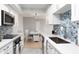 Modern kitchen with white cabinets and stainless steel appliances at 10355 Paradise Blvd # 207, Treasure Island, FL 33706