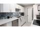 Modern kitchen with white cabinets and stainless steel appliances at 10355 Paradise Blvd # 207, Treasure Island, FL 33706