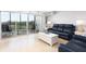 Living room with water views and access to balcony at 10355 Paradise Blvd # 207, Treasure Island, FL 33706