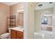 Bathroom with vanity, toilet and access to living area at 10704 Mira Vista Dr, Port Richey, FL 34668