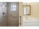 Bathroom with a shower, grab bar, and window at 10704 Mira Vista Dr, Port Richey, FL 34668