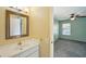 Bathroom featuring a vanity, mirror, and adjacent bedroom view, offering convenience and functionality at 10704 Mira Vista Dr, Port Richey, FL 34668