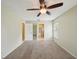 Bright bedroom featuring a ceiling fan and en-suite bathroom at 10704 Mira Vista Dr, Port Richey, FL 34668