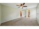 Spacious bedroom with ceiling fan and en-suite bathroom access at 10704 Mira Vista Dr, Port Richey, FL 34668