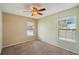 Bedroom featuring neutral walls, ceiling fan and natural light, offering a blank canvas for personalization at 10704 Mira Vista Dr, Port Richey, FL 34668