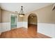 Spacious dining room with wood floors and a light fixture at 10704 Mira Vista Dr, Port Richey, FL 34668