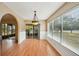 Bright dining room with wood floors, slider, and window at 10704 Mira Vista Dr, Port Richey, FL 34668