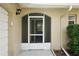 House entrance with a screened door and tiled flooring at 10704 Mira Vista Dr, Port Richey, FL 34668