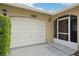 White garage door and screened entryway at 10704 Mira Vista Dr, Port Richey, FL 34668
