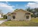 Tan house exterior with landscaping and a driveway at 10704 Mira Vista Dr, Port Richey, FL 34668