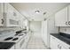 White kitchen cabinets, granite countertops, and appliances at 10704 Mira Vista Dr, Port Richey, FL 34668