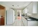 White kitchen cabinets, granite countertops and appliances at 10704 Mira Vista Dr, Port Richey, FL 34668