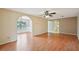 Living room featuring hardwood floors, arched doorways, and ceiling fan, offering a spacious and inviting atmosphere at 10704 Mira Vista Dr, Port Richey, FL 34668