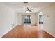 Living room with hardwood floors, ceiling fan, and sliding glass doors at 10704 Mira Vista Dr, Port Richey, FL 34668