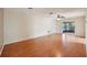 Spacious living room with hardwood floors and sliding glass doors providing access to outdoor area, bright and airy at 10704 Mira Vista Dr, Port Richey, FL 34668