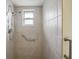 Walk-in shower with grab bars and tiled walls at 10704 Mira Vista Dr, Port Richey, FL 34668