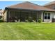Spacious backyard with screened enclosure and lush green lawn at 10880 Cory Lake Dr, Tampa, FL 33647
