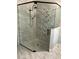 Modern glass shower with geometric tile accents at 10880 Cory Lake Dr, Tampa, FL 33647