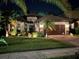 Beautiful home exterior at night with landscaping at 10880 Cory Lake Dr, Tampa, FL 33647