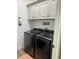 Convenient laundry room with modern washer and dryer at 10880 Cory Lake Dr, Tampa, FL 33647