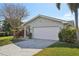 House exterior with a white garage door and lush landscaping at 11146 131St Ave, Largo, FL 33778