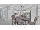 Cozy dining area with seating for six and a modern kitchen visible in the background at 12829 Tallowood Dr, Riverview, FL 33579