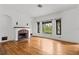 Spacious living room with hardwood floors and a tiled fireplace at 136 26Th Ne Ave, St Petersburg, FL 33704