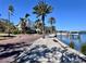 Brick-paved waterfront path with palm trees and upscale homes at 136 26Th Ne Ave, St Petersburg, FL 33704