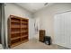 Well-lit bedroom with built-in shelves and double doors leading to a bathroom at 13607 Circa Crossing Dr, Lithia, FL 33547