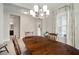 Dining room with a wooden table and access to a hallway at 13607 Circa Crossing Dr, Lithia, FL 33547