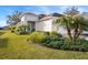 Well-maintained house with a landscaped yard and palm trees at 13607 Circa Crossing Dr, Lithia, FL 33547