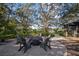 Fire pit with chairs surrounded by trees and a view of a lake at 13607 Circa Crossing Dr, Lithia, FL 33547