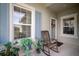 Front entry with rocking chair and potted plants at 13607 Circa Crossing Dr, Lithia, FL 33547