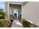 Front porch with blue shutters, plants and wooden chairs at 13607 Circa Crossing Dr, Lithia, FL 33547
