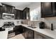 Modern kitchen with stainless steel appliances and dark cabinetry at 13607 Circa Crossing Dr, Lithia, FL 33547