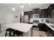 Kitchen with dark cabinets, quartz countertops and island at 13607 Circa Crossing Dr, Lithia, FL 33547