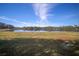 Serene lakefront property with grassy areas and mature trees at 13607 Circa Crossing Dr, Lithia, FL 33547