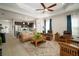 Open living room with adjacent kitchen and access to patio at 13607 Circa Crossing Dr, Lithia, FL 33547