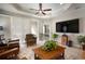 Living room with hardwood floors, large TV, and comfy seating at 13607 Circa Crossing Dr, Lithia, FL 33547