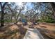 Playground nestled within a wooded area, offering a fun and safe play space for children at 13607 Circa Crossing Dr, Lithia, FL 33547