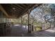 Spacious covered porch with comfortable seating and tranquil natural views at 13607 Circa Crossing Dr, Lithia, FL 33547