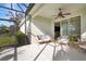 Cozy screened porch with seating and access to the interior at 13607 Circa Crossing Dr, Lithia, FL 33547